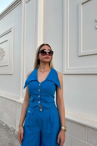 Detailed texture of royal blue two-piece linen set featuring button-up vest and high waist