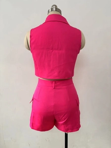 Rear view of vibrant magenta two-piece sleeveless vest and high-waisted cargo shorts set
