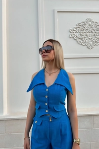 Close-up of blue linen vest with wooden buttons and matching shorts set for women
