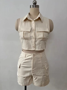 Detail of cargo style two-piece set featuring sleeveless button shirt and matching shorts
