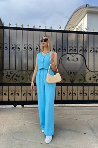 Full view of light blue vest and high-waist wide-leg trousers in breathable linen fabric