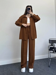 Close-up of brown oversized long-sleeved shirt with pocket and matching wide-leg trousers