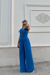 Detail of royal blue summer two-piece set featuring a buttoned vest and wide-leg trousers