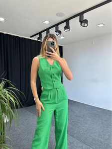 Detail of green linen-textured two-piece set with V-neck vest and high-waist trousers