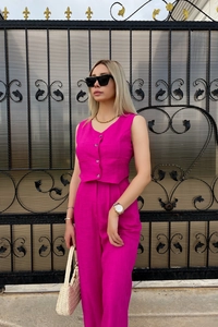 Detailed texture of rose pink vest top and trousers set on a stylish woman outdoors