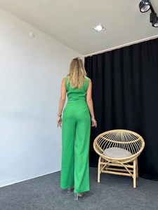 Detail view of high-waisted green wide-leg trousers and sleeveless top from the back