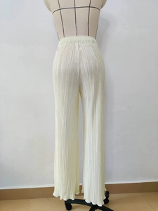 Detail of high-waisted pleated wide-leg trousers in creamy white on a mannequin back view