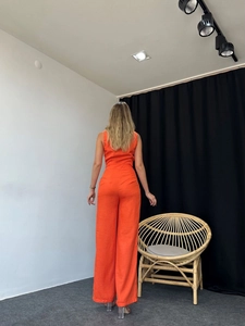 Back view of orange sleeveless top and high-waist wide-leg trousers set with linen texture