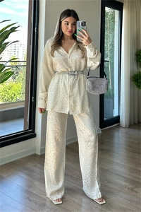 Detail of satin leopard jacquard two-piece set featuring long-sleeved shirt and wide-leg pants