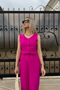 Detail of rose red vest and wide-leg trousers set in linen blend with fabric texture