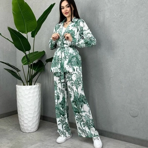 Women's tropical print two-piece set featuring long-sleeve belted top and wide-leg pants