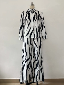 Close-up of zebra print shirt buttons and texture on high-waist wide-leg pants
