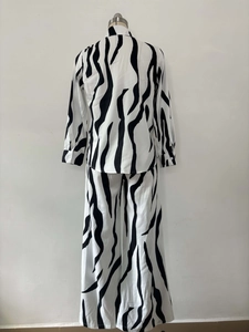 Detail of zebra print texture and stitching on long sleeve shirt and wide leg trousers