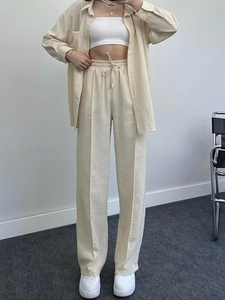Detailed full-body view of a beige three-piece set featuring wide-leg drawstring pants