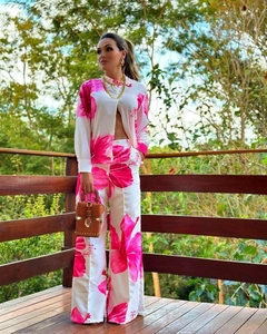 Detail of pink floral print shirt and wide-leg trousers set with a tropical vacation vibe
