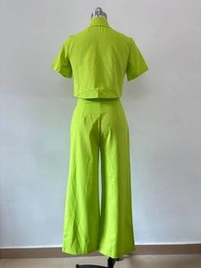 Rear view of neon green short sleeve top and high waist wide leg pants set in linen texture