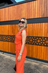 Detailed texture of orange cotton linen vest and high-waist straight trousers set