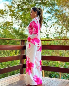 Detail of white two-piece set featuring vibrant fuchsia hibiscus floral print patterns