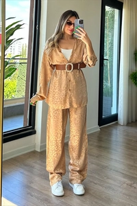 Detail of satin leopard print two-piece set featuring long-sleeved shirt and wide-leg pants