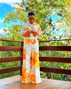 Detail of white two-piece set with orange floral prints and front tie-up shirt