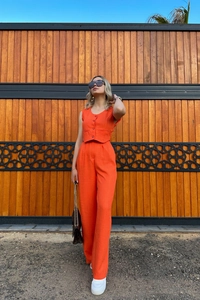 Detailed texture of vibrant orange vest and high-waist wide-leg trousers two-piece set