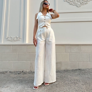 Women's two-piece cream linen suit with V-neck sleeveless vest and wide-leg trousers