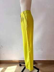 Side view of high-waisted bright yellow wide-leg trousers on a mannequin bust