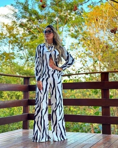 Detail of zebra print two-piece set featuring long sleeve shirt and wide leg pants
