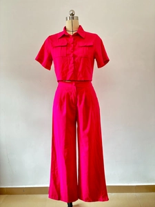 Front view of hot pink women's two-piece set with short sleeve shirt and wide-leg pants