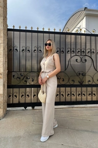 Elegant beige two-piece linen set with cropped vest and high-waist wide-leg trousers