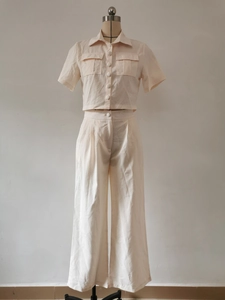Detail of short sleeve lapel shirt with utility pockets and high waist wide leg pants