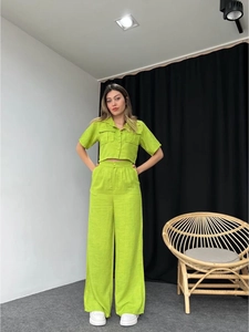 Green summer set featuring a short-sleeve buttoned shirt and high-waist wide-leg pants