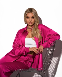 Close-up of elegant rose pink satin two-piece set with silk-like sheen and drape