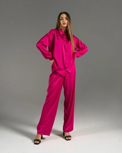 Close-up of elegant magenta satin two-piece set showing silky fabric and lapel detail
