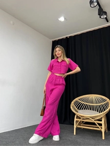 Detail of rose pink short-sleeved shirt and high-waisted wide-leg trousers set
