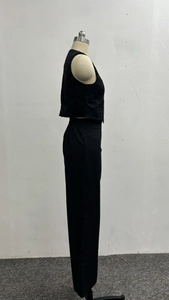 Side view of a black two-piece set featuring a tailored vest and trousers on a mannequin