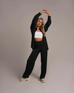 Detailed texture of black satin two-piece lounge set with long-sleeved shirt and wide-leg pants