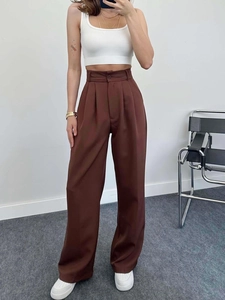 Detail of high waisted wide leg dark brown trousers with elegant front pleat design