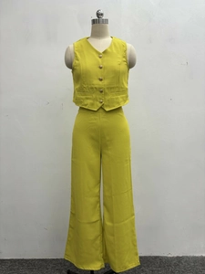 Detailed front view of ginger yellow V-neck vest and matching wide leg trousers on mannequin