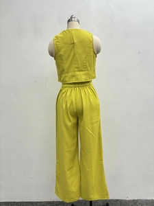 Detail of lime green sleeveless crop top and high-waist wide-leg trousers set