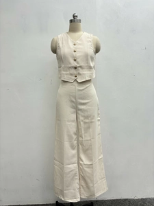 Detail view of the single-breasted V-neck vest and matching high-waisted wide-leg trousers