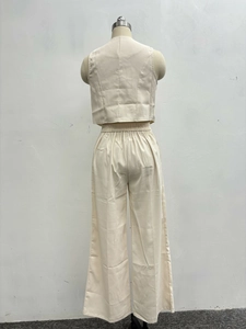 Back view of cream two-piece set featuring sleeveless crop top and elastic wide-leg pants