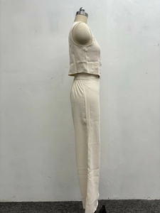 Detail shot of beige vest and wide-leg trousers set with elastic waistband design