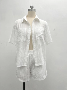 Detail of white hollow embroidered short sleeve shirt and shorts summer set for women