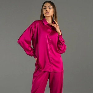 Elegant deep pink satin two-piece set featuring long sleeve shirt and relaxed wide trousers