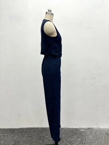 Detail of navy blue two-piece set featuring high-waist straight trousers and vest