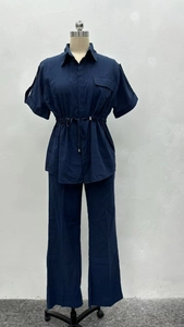 Detail of navy blue short-sleeve shirt with drawstring waist and cargo pockets