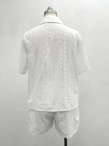 Detail view showing the back of a white eyelet embroidery shirt and matching shorts set