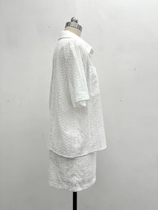 Detailed view of white eyelet embroidery on women's cotton summer short sleeve shirt