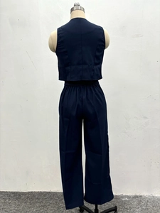 Rear view detail of navy blue two-piece set featuring vest and wide-leg trousers